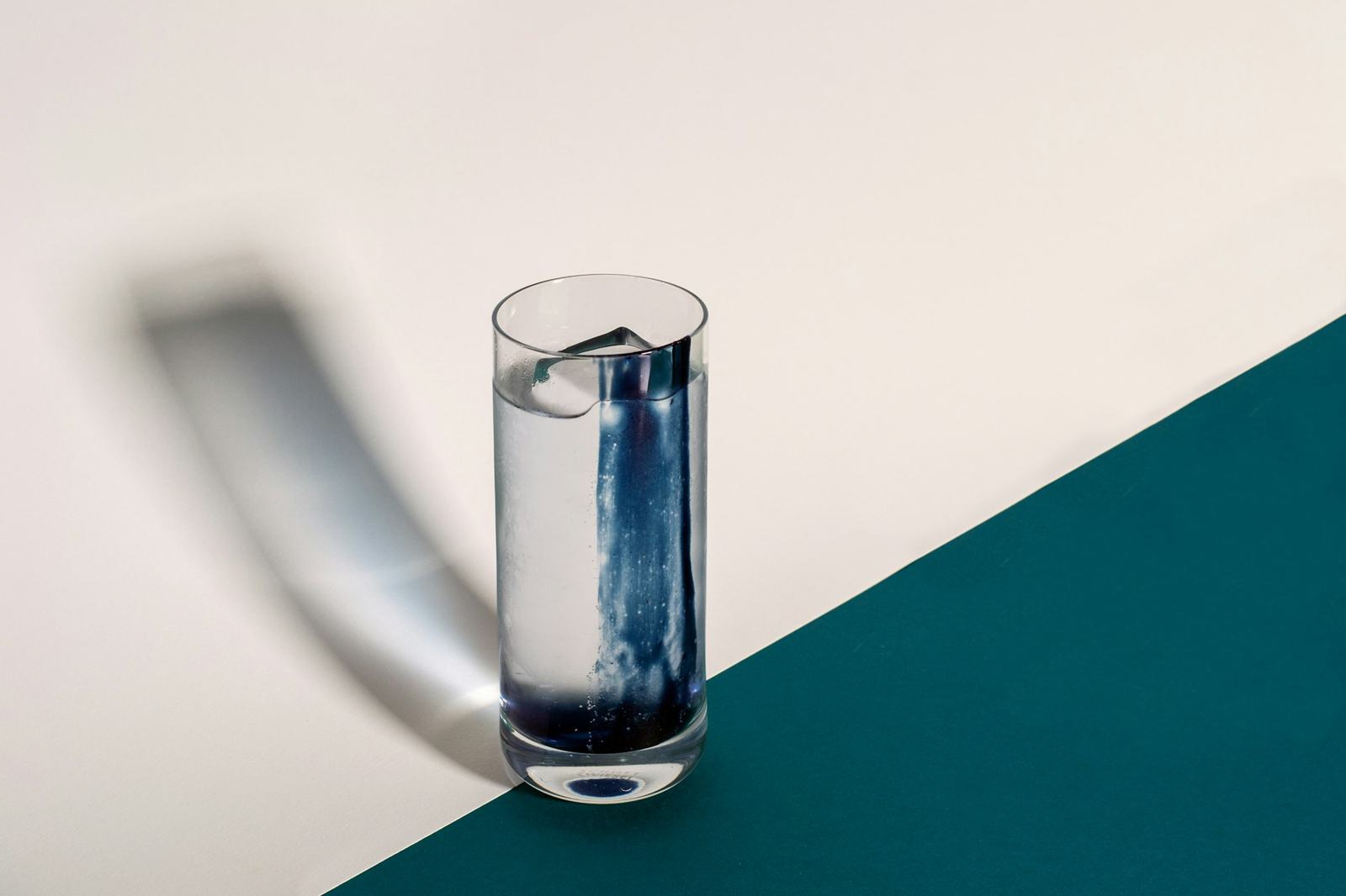A clear glass of water on a white surface
