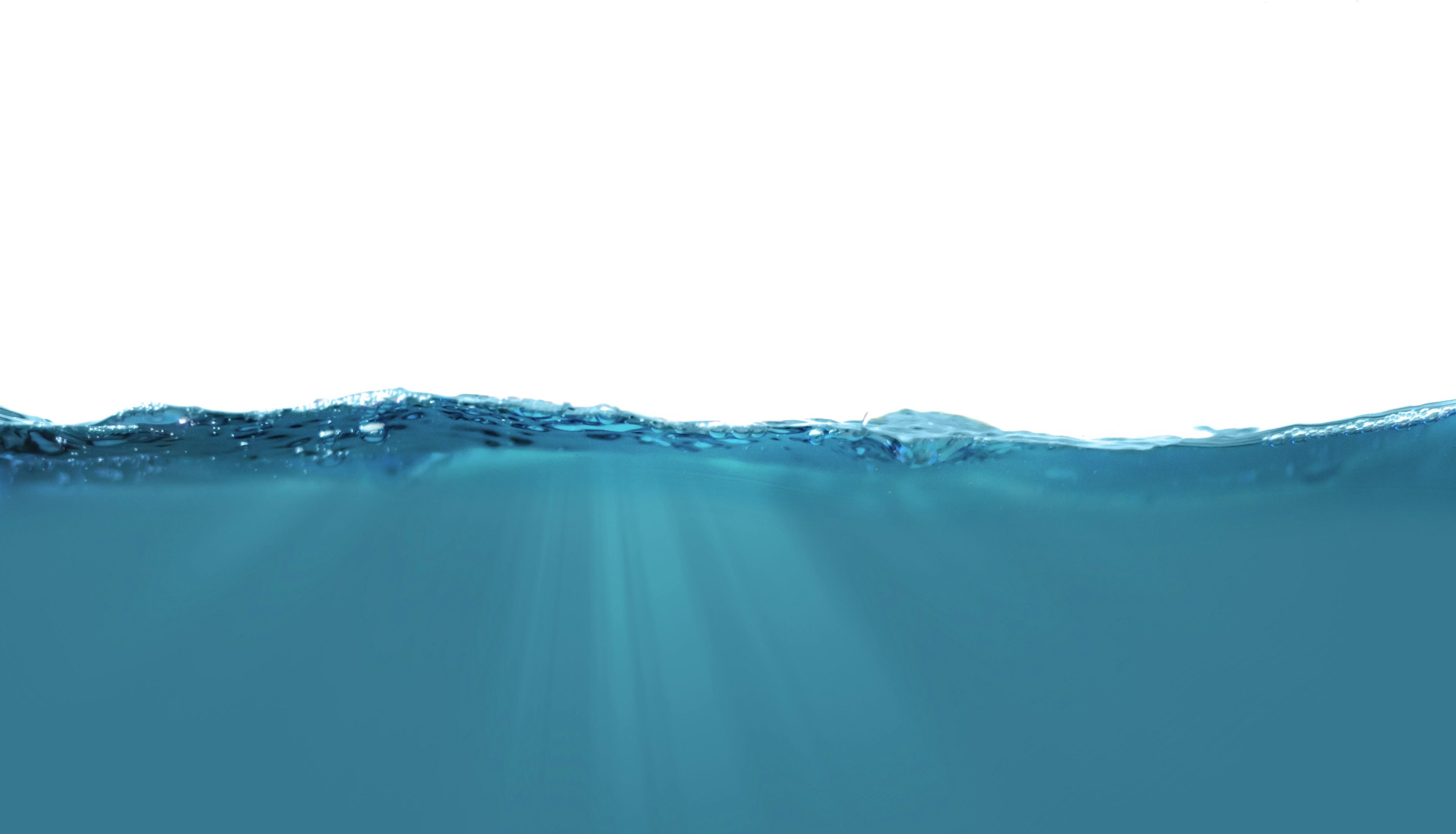 Clear teal water seen at the surface line under a pure white sky